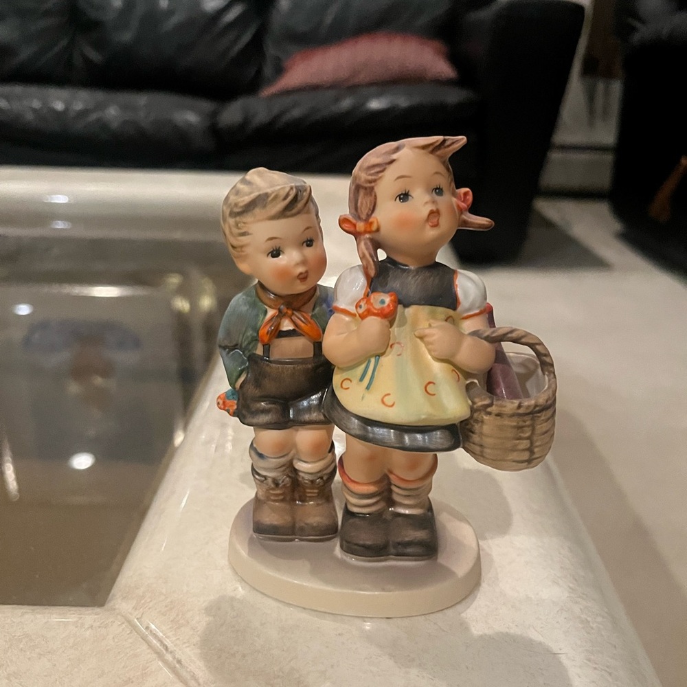 Mid-century “Home From Market" Hummel figurine with a stylized bee mark